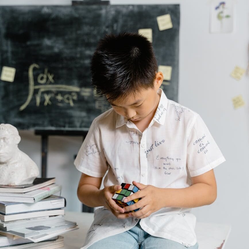 a boy solving a rubik s cube
