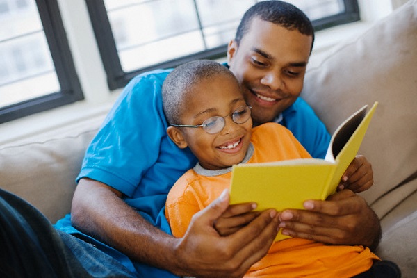 Dad reading with son to teach phonics