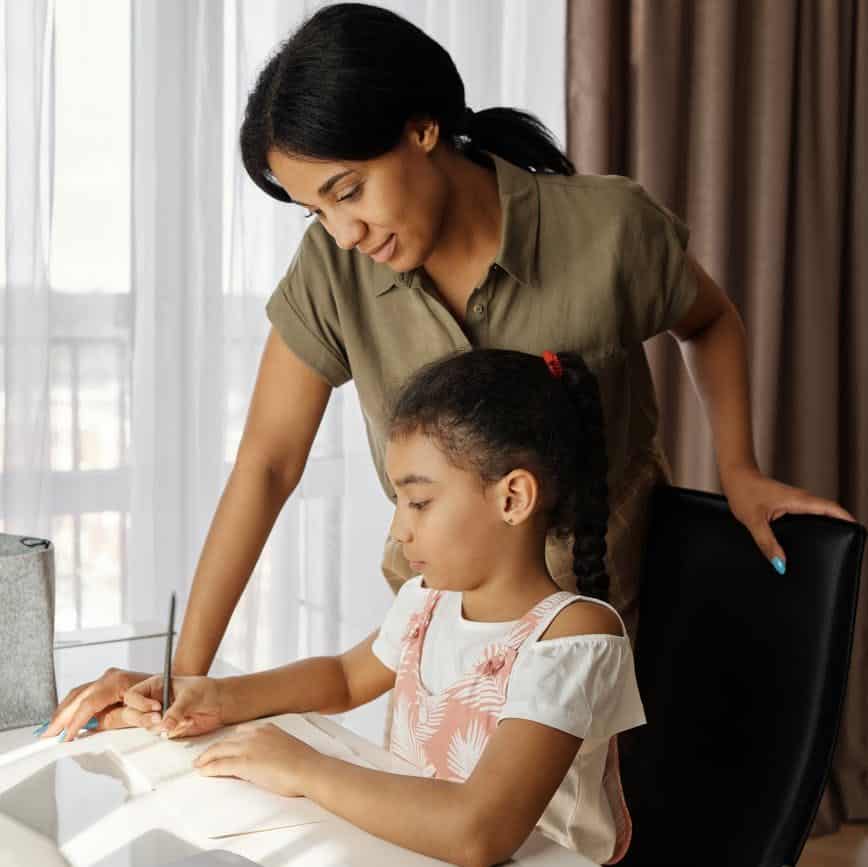 mother helping her daughter with homework