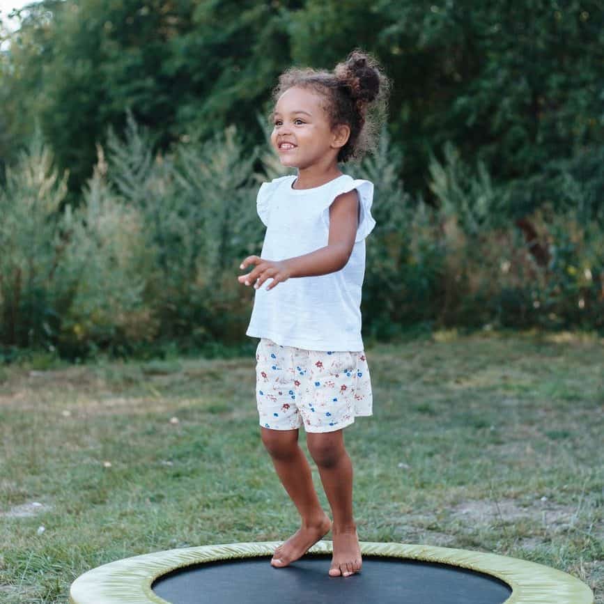 a young girl playing trampoline