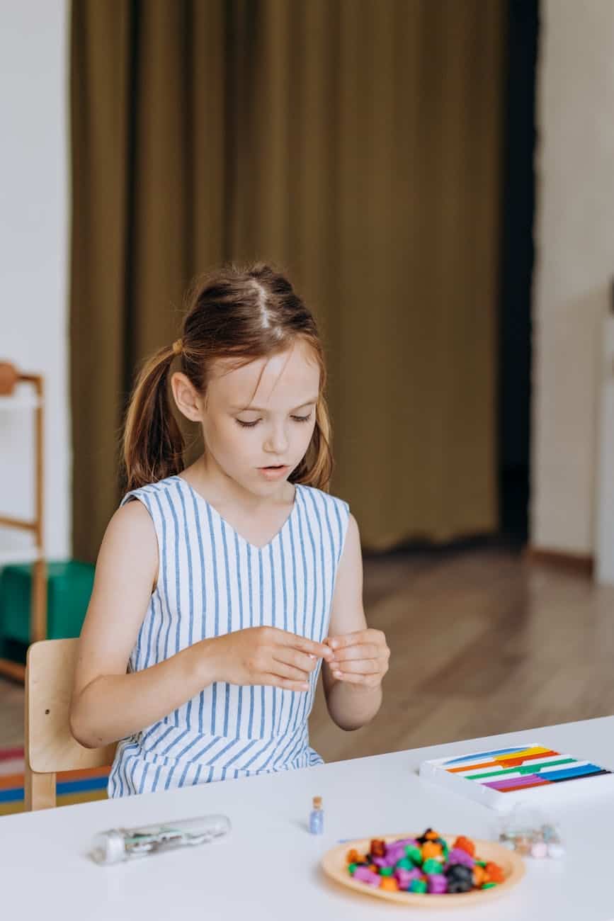 a girl doing a school activity inside a classroom