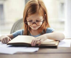 girl with glasses reading book